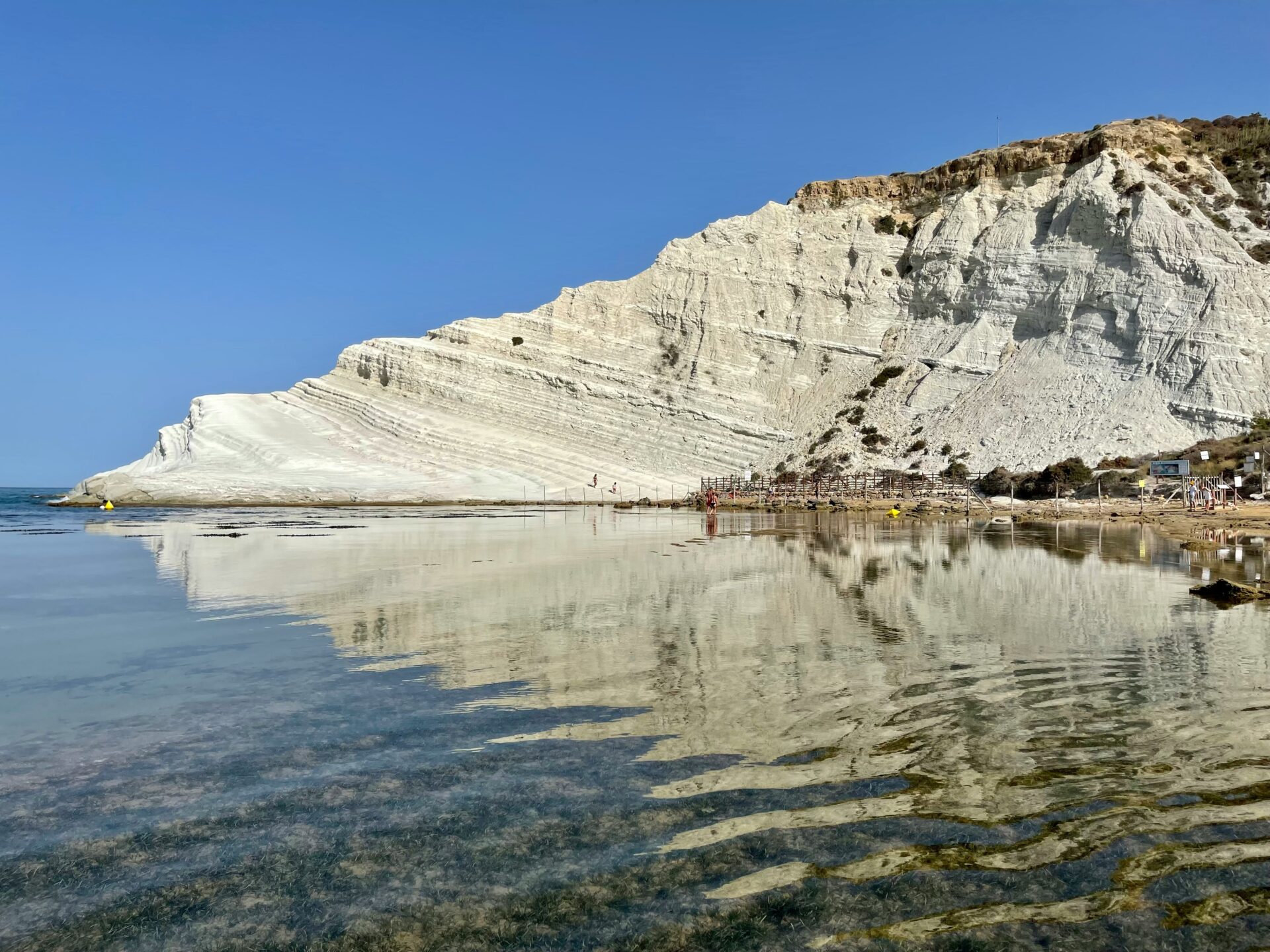 Boat approaching the Scala dei Turchi white cliffs from the sea